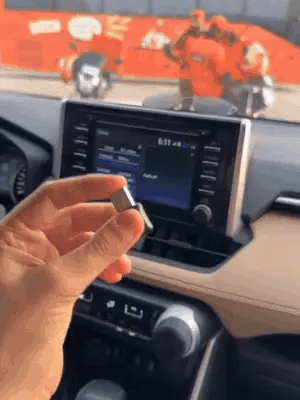 Wireless Car Play adapter by My Store shown connected to a car dashboard with a smartphone interface on the screen.