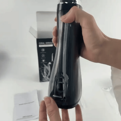 Iqbal's Cart Oral Irrigator device for dental hygiene, showing the sleek design and water nozzle in a close-up shot.